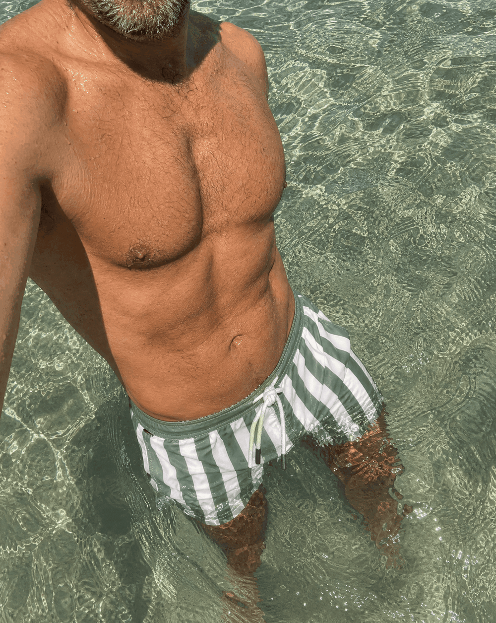 summercampaign in the south of france with european model age approx 45, with beard and french moviestar looks @Craig Comfort Fit swim shorts